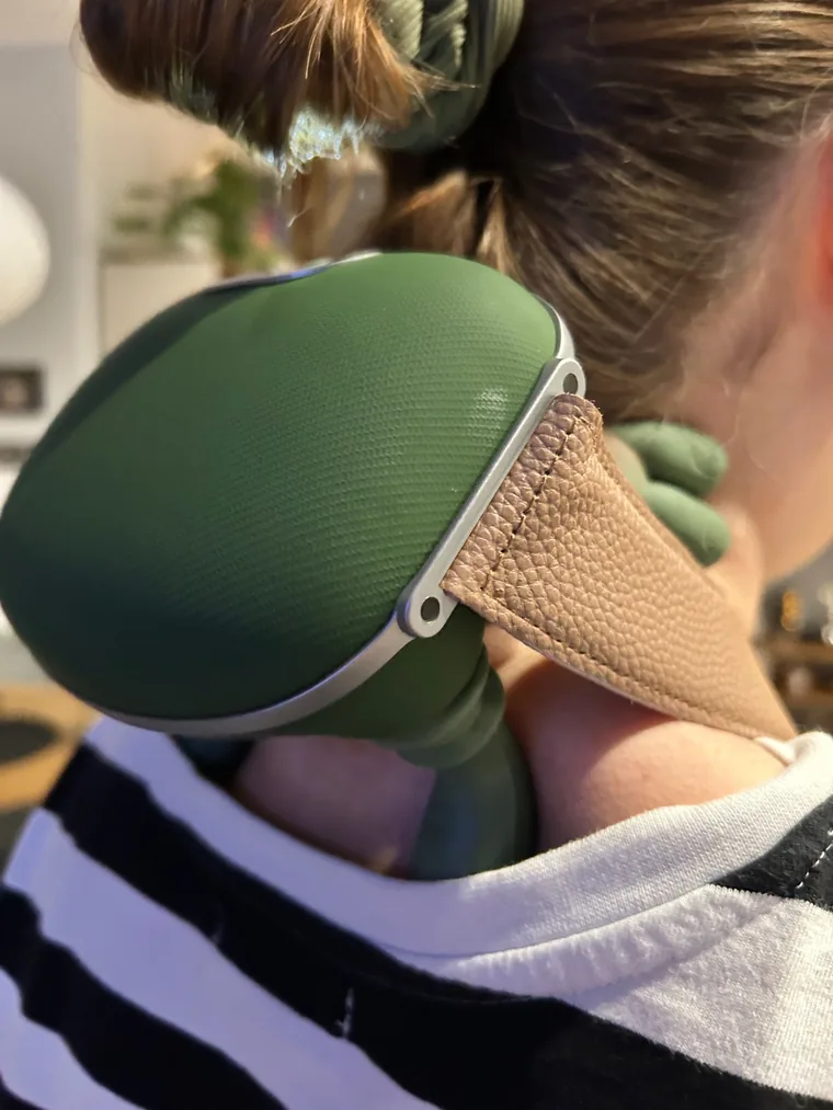 The Nodly massager worn over the neck and shoulders, seen from behind, adjustable strap in place